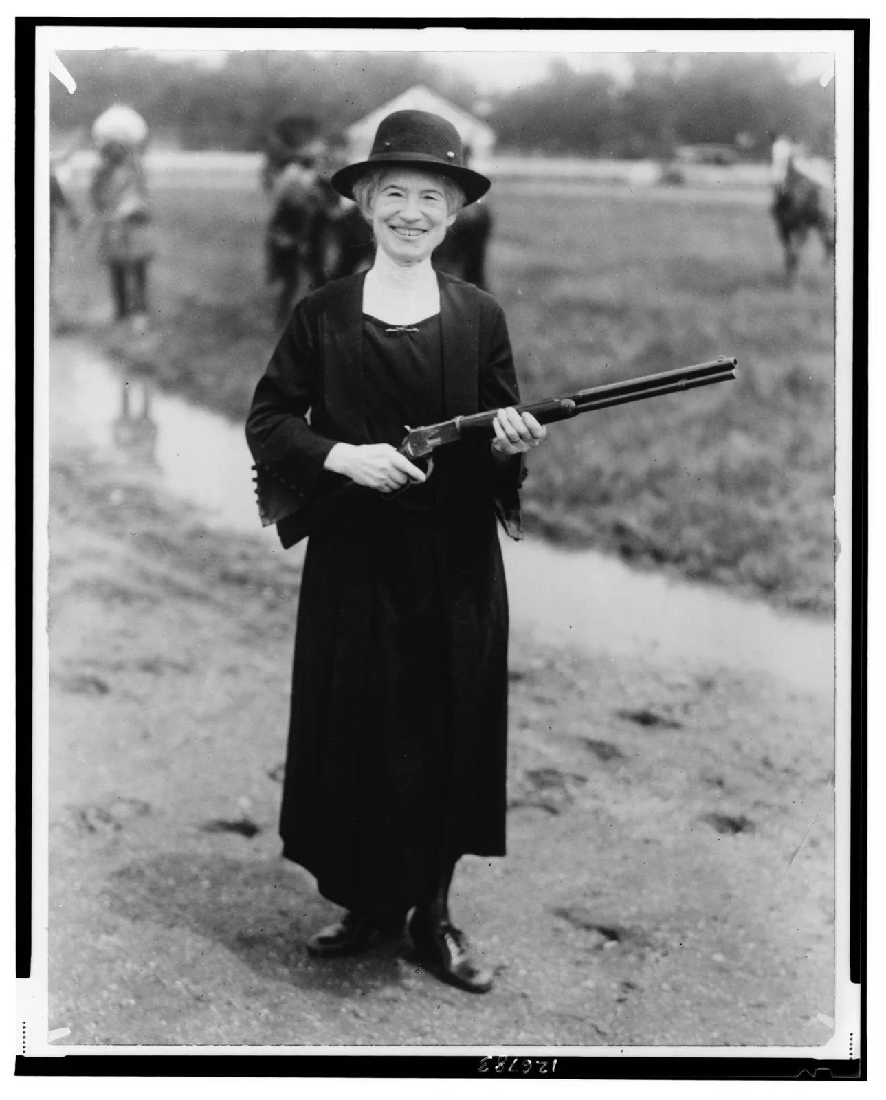 Annie Oakley holding a rifle
