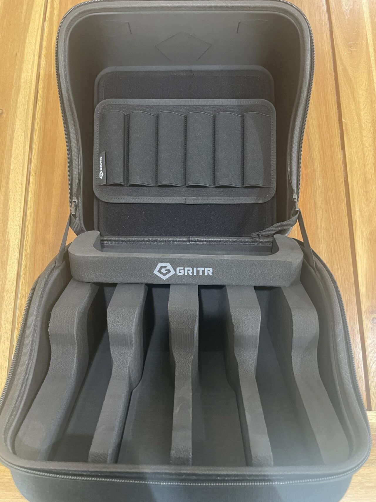 Open GRITR Pistol Pod with four foam handgun slots and six magazine pouches in the lid