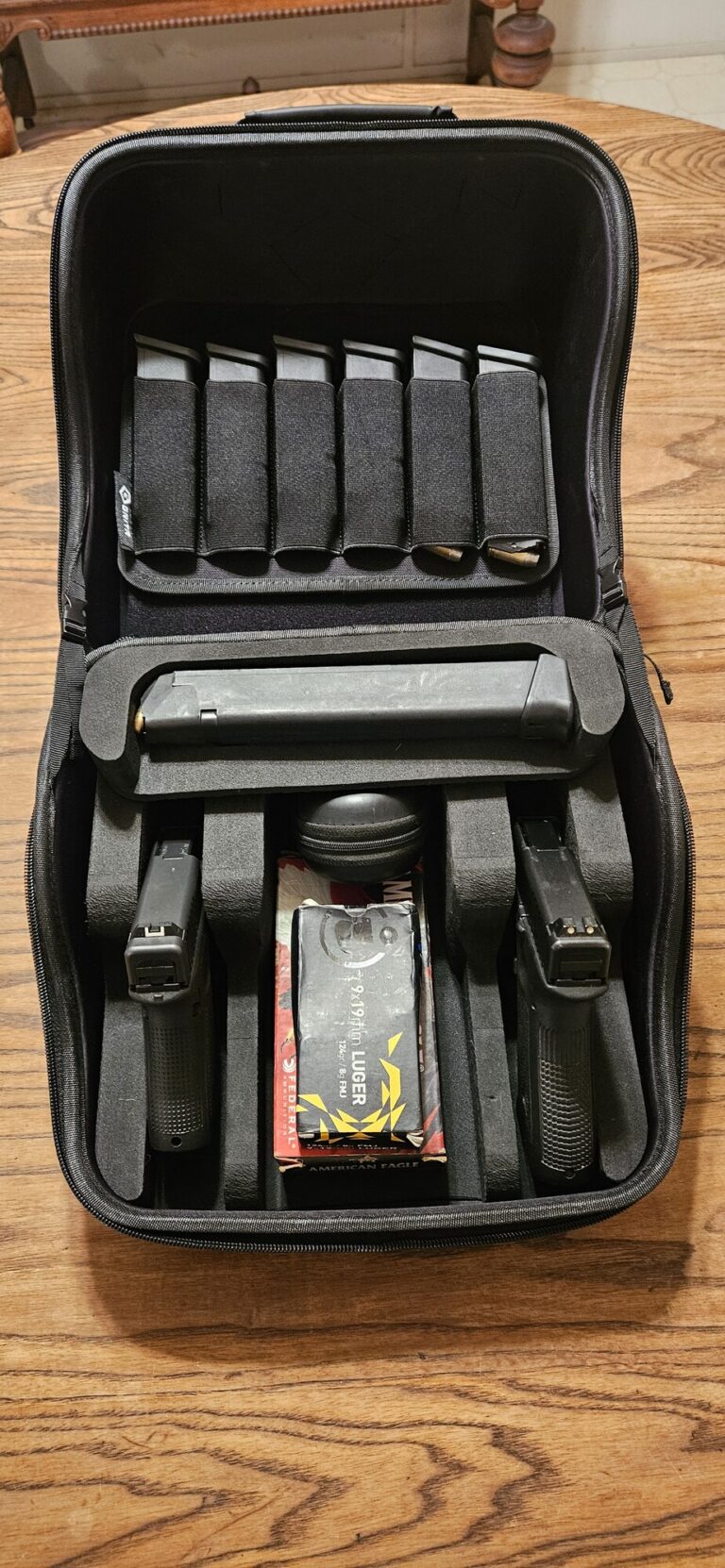 Two-pistol GRITR Pistol Pod load with ammunition, extended magazine, and hearing protection